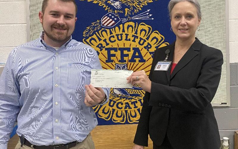 Seth Davis received a Farm to School check for Fannin County Middle School from Martha Williams.