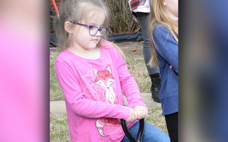 Cali Flowers stands ready to help plant the Serviceberry tree in honor of Arbor Day.