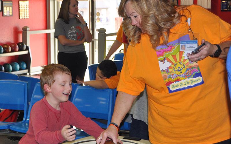Blue Ridge Elementary first grader Sterling Shook is all smiles as he gets ready for his turn to bowl at last week’s Special Olympics event. Pictured with him is Tammy Pierce.