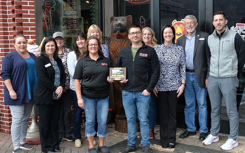 Heather Hawkins and Jesse Hawkins proudly show off their plaque recognizing Happy Bear Ice Cream as a new member of the Polk County Chamber of Commerce. The plaque was presented by Chamber representatives, from left, Kat Yoeman, Jenny Munty, Colleen Fults, Sarah Berry, Ellen Raper, Lynne McClary, Amanda Hill, James Woody, and Byran Clary during a special last Thursday in McCaysville.