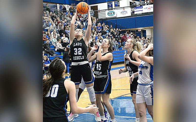 Fannin’s Macy Hawkins (32) snags a rebound with Reese Lewis (45) and Avi Ethington (30) ready to help in recent Lady Rebel action.
