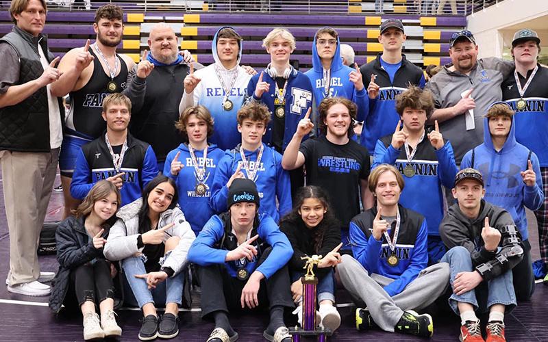 The Fannin Rebels Wrestling team smiles after securing the Area 8AA Traditional Championship Saturday, February 4, at Union County High School. Shown are from left, front row, Mikayla Holloway, Emma Shaw, Thomas Golden, Angela Alvarez, Taylor Collis and Tristan Siler; middle row, Carson Collis, Finn Thoreson, Landon Poole, Colby Shaw, Matthew Crowder, Drake Cantrell; and back roq, Coach Alan Collis, Logan Long, Coach Wade Hodges, Corbin Davenport, Blake Summers, Cooper Moreland, Jackson Mercer, Head Coach C