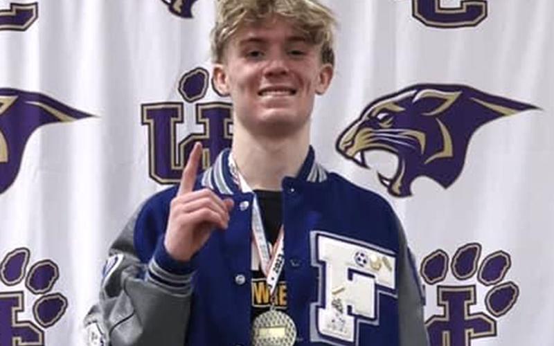 Fannin County junior Blake Summers stands on the first place podium after his 100th varsity win for the Area Championship Saturday, February 4, at Union County High School.