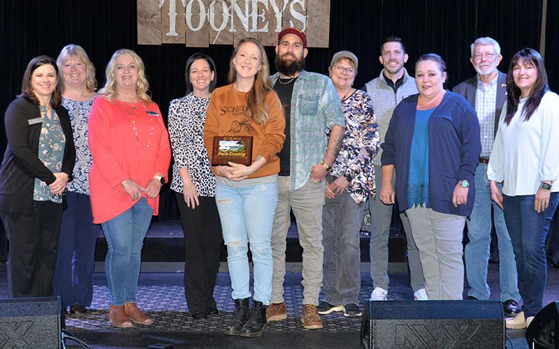 Tooney’s Music Venue in McCaysville was one of four Copper Basin area businesses welcomed by the Polk County Chamber of Commerce as members last week. Shown during a plaque presentation are chamber and Tooney’s representatives, from left, Jenny Mundy, Ellen Raper, Lynne McClary, Amanda Hill, Emily Hawkins and Joshua Hawkins from Tooney’s, Colleen Fults, Bryan Clary, Kat Yeoman, James Woody, and Sarah Berry.
