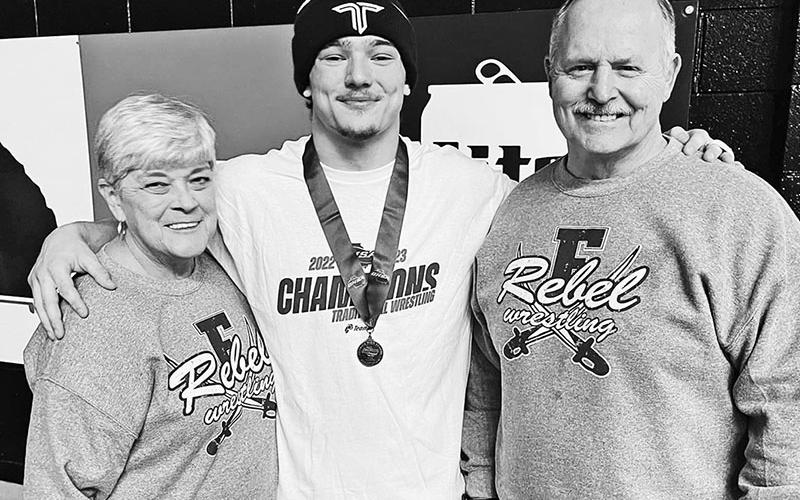 This picture shows Doug and Marsha Davenport celebrating with their grandson Corbin after his state wrestling championship in 2023.