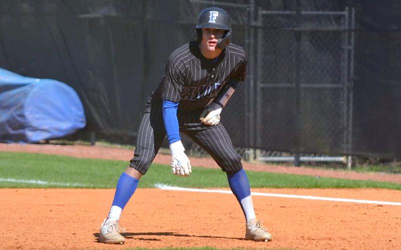 Senior Bryson Holloway gets ready to make a play as he watches the pitch from first base.