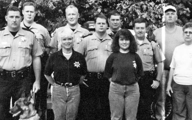 This photo shows the East Polk County staff of the sheriff’s office. The exact year could not be determined. From left are, front, dispatchers Laverne Collins, Becky Cearley, and Bobbie Waters; and standing, K-9 Deputy Sheriff Mike Mull with Bernard, Deputy Brian Fields, Chief Deputy Lew Crawford, Deputy Bill Cherry Jr., Deputy Randy Swafford, Deputy Keith Barker, and dispatcher Markie Huffman. Not pictured are deputies Weldon Boring and Brian Epperson and Detective Kevin Cole.