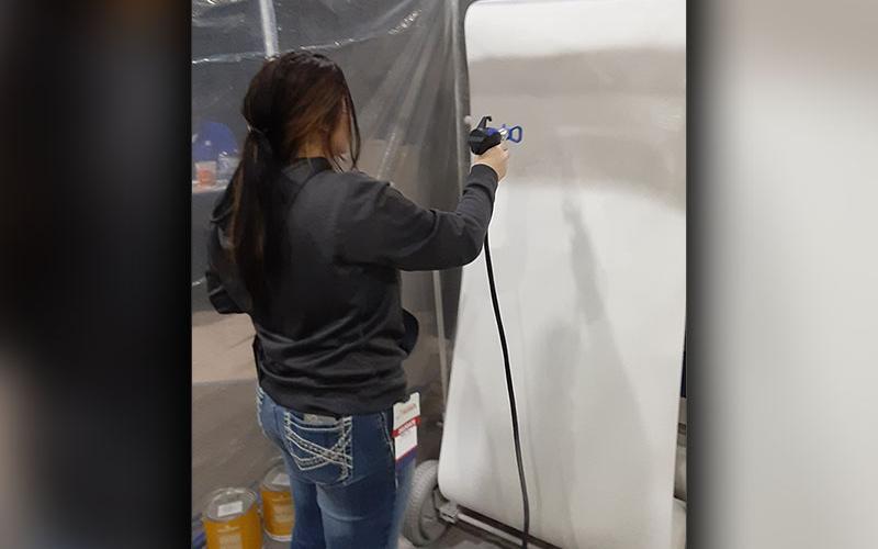 Chelsey Frye works on a painting project at the SkillsUSA state conference in Atlanta.