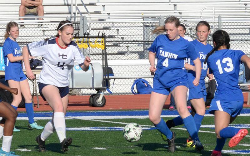 Lady Rebel Caroline Young (#4) navigates the ball through the Haralson County defenders Friday, March 24, for a 5-0 victory. Fannin County hosted Haralson in a region matchup.