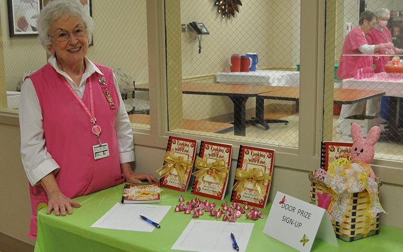 Hospital Auxiliary President Shirley Copeland made sure everyone signed up to win a door prize at the appreciation reception hosted by the Pink Ladies.