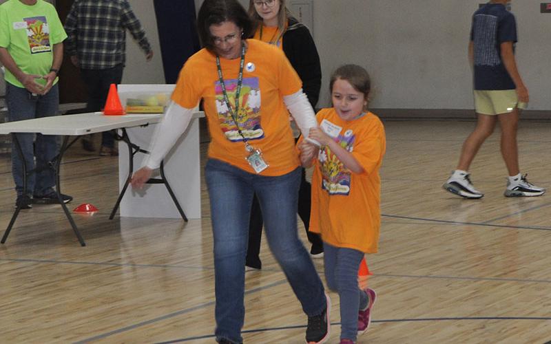 Corrie Cochran from Mountain Area Christian Academy (MACA) gets a little help racing to the finish line from MACA staff member Kim Thomas. The Special Olympics Track and Field event was moved indoors to the Fannin County Recreation Department last Friday due to the threat of rain.