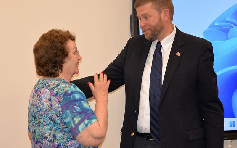 Faye Sisson extends congratulations to Dr. Michael Gwatney at his retirement reception last week.