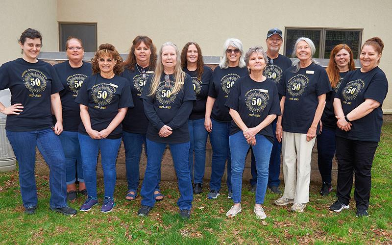 The staff at Mineral Springs Center gathered during the 50th Anniversary Celebration at the facility in Blue Ridge. Shown are, from left, Faith Fuller, Tara Ledford, Angie Green, Stacey Nicholson, Karen Kinchen, Cindy Moss, Robin Davenport, Carol Brown, David Messer, Diane Bond, Kelly Messer, and Tina Banner. Not pictured are Holly Waters and Penny Bradburn.