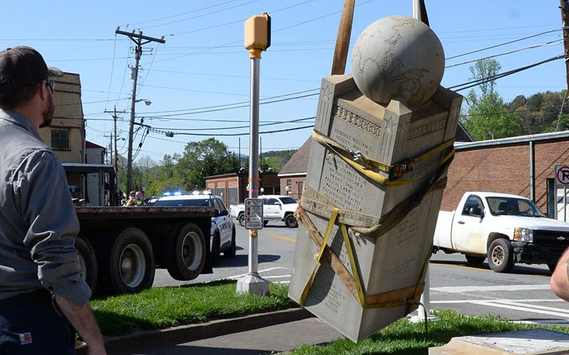 McCaysville Water Department Superintendent Davy Ensley watches as the Veterans Monument breaks free of its base. During the move, the monument was estimated to weigh six tons.