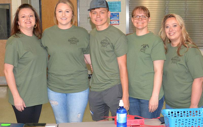 Dawn Cochran, Lauren Watkins, Stephen Dickey, Sarah Dickey and Kim Callihan, from left, were busy coordinating Riding the Ridge Saturday morning at Fannin County Middle School. A total of 44 Jeeps were signed up to participate in the event that traditionally kicks off fundraising for Shop With a Cop.