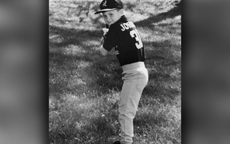 A young Jordan Farmer is shown batting for a photo.