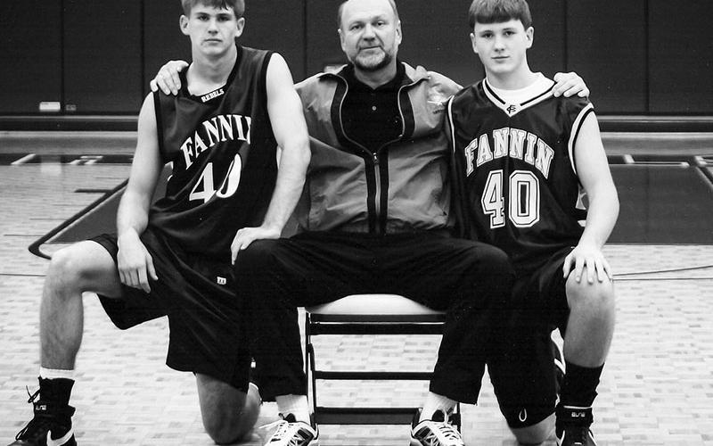 Jordan Farmer, right, is pictured with his father Johnny, center, and brother Jonathan, left, at the Fannin County High School gym.