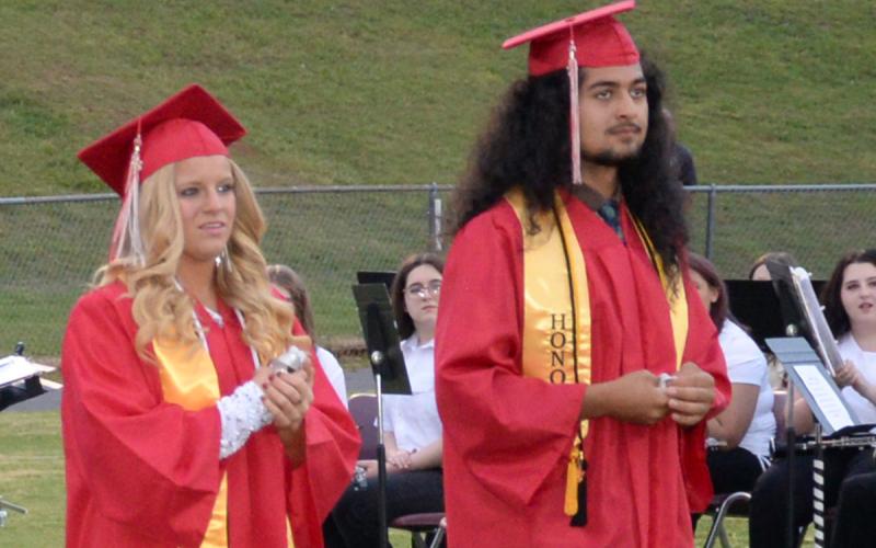 Destiny Pittman and Krus Soto wait to receive their high school diplomas.