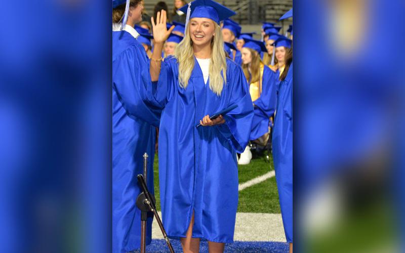 Hannah Sosebee smiles and waves after taking hold of her high school diploma Friday night at Fannin County High School.