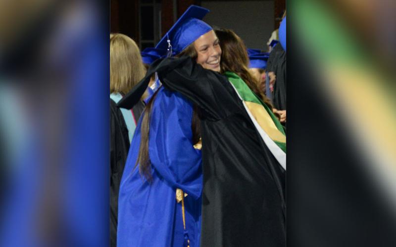 Madison Ponton gets a hug from Shannon York after receiving her high school diploma.