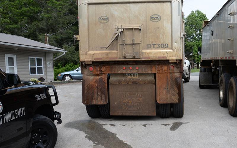 Liquid can be seen coming from the trailer of one of two Atomic Transport trucks after it was stopped by law enforcement officers last week.