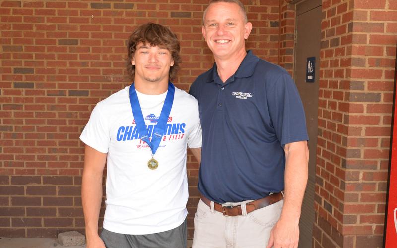 State Champion Pole Vaulter Corbin Davenport, left, is pictured with coach and Fannin’s last pole vaulting State Champion Chad Galloway, right.