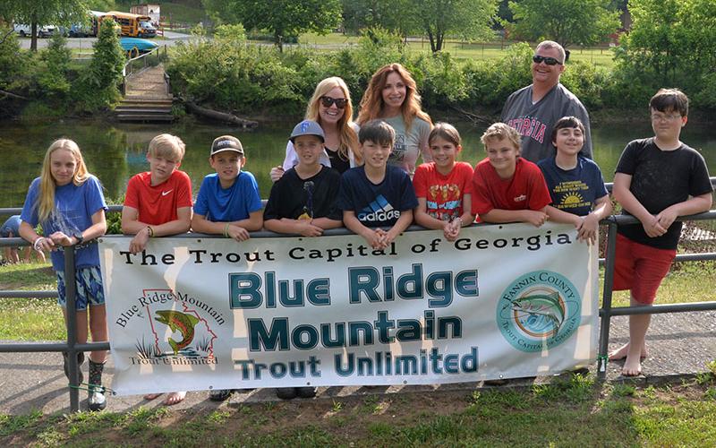 These Fannin County Middle School students, along with their teachers and assistant principal, released rainbow trout into the Toccoa River just before the end of school. Shown are, from left, front, Jacquelyn Cline, Kendrick Pack, Zane Perkins, Alex Ware, Alex Barber, Jayden Collins, Cash Ades, Corey O’Quinn, and Stewie Gustin; and, back, Exploratory teachers Tori Arp and Althea Gobble and Assistant Principal Matt Rosenberger.