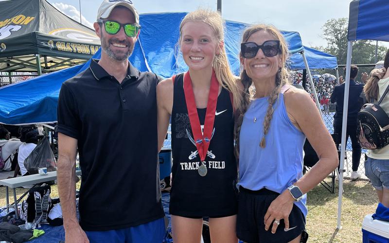 Sophomore Lindsey Holloway qualified for all four of the GHSA State Championship in her events and medaled in three out of the four. Shown are, from left, Mid/Long Distance Coach Lucas Roof, Lindsey Holloway, Head Coach Miranda Roof.