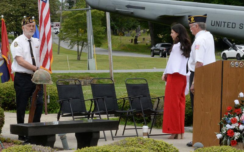 Steve Strickland retires the colors as Reese Lindstrom and Bill Stodghill look on at the conclusion of the Memorial Day ceremony.