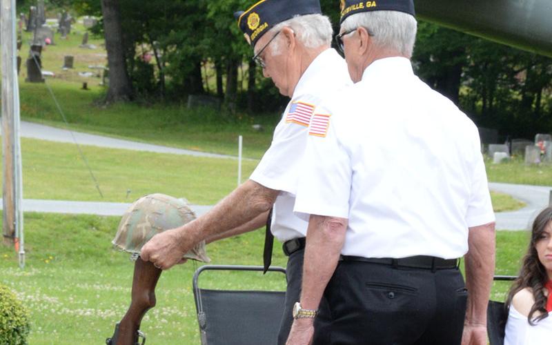 The Boots and Helmet memorial signifies a soldier’s last march onto the battlefield. The solemn ceremony was part of the Memorial Day observance at Veterans Memorial Park.