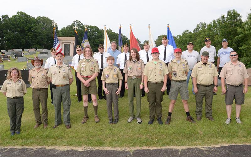 Members of several veterans organizations including the North Georgia Honor Guard joined with Boy Scouts from Troop 32 in Epworth for a ceremony and to place flags on the graves of veterans at Crestlawn Cemetery on Mobile Road. Shown at the conclusion of the event are, from left, front, Glenda Green, David Lewis, Nick Wimberley (also a veteran) Mathew Monroe, Clay Dillard, Stephen Young, Roy Green, Maddix Trantham, Raymond Green, and Tony Young, and, back Steve Strickland, Chris McKee, Richard Crosley, Bill