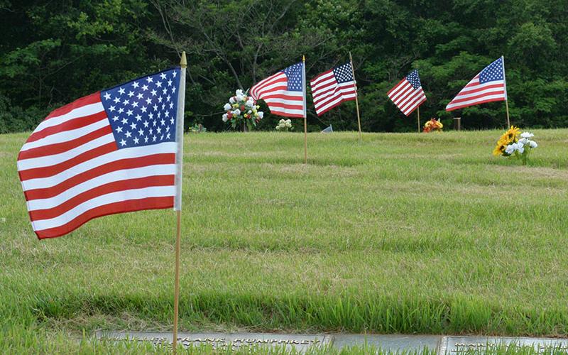 Flags fly in honor of departed veterans.