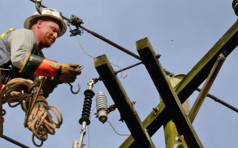 Tyler Watkins works high above Blue Ridge Drive Sunday afternoon to restore power to Tri-State EMC members in McCaysville. Crews were still working Tuesday morning to fix problems as 1,490 customers were reported without electricity.