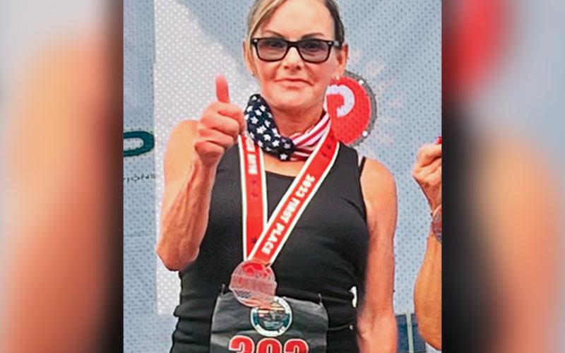 Sherry Roof of Mineral Bluff gives a thumbs up after taking first place honors in the Female 70 to 99 age group in the July 4 Freedom 5K.
