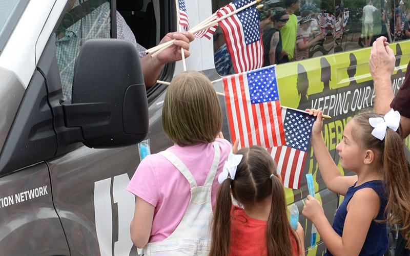 Children gather to receive free flags from Chapter 28 of the Disabled American Veterans.
