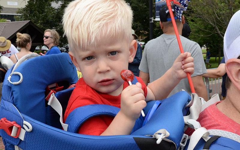 This young man seemed to be more interested in other things than the parade.