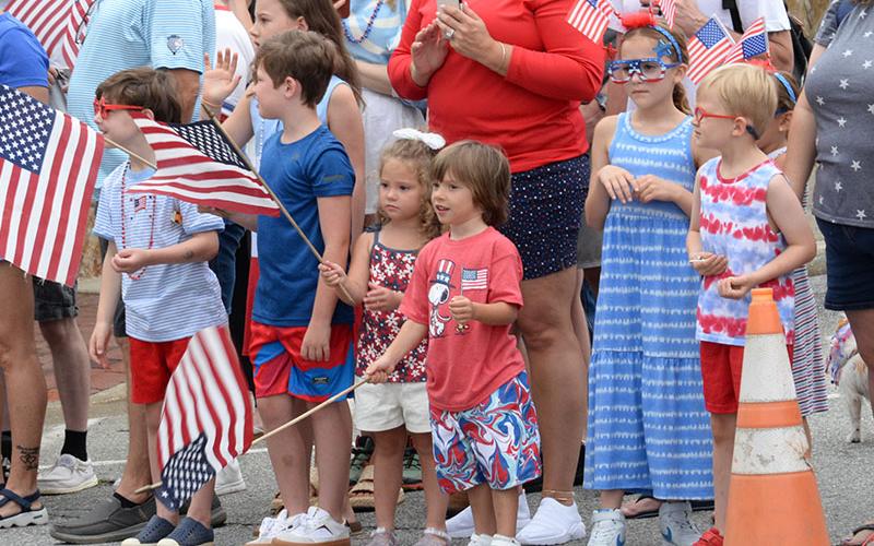 United States flags waved, left photo, as emergency equipment carrying a variety of riders made its way through the parade route in downtown Blue Ridge.
