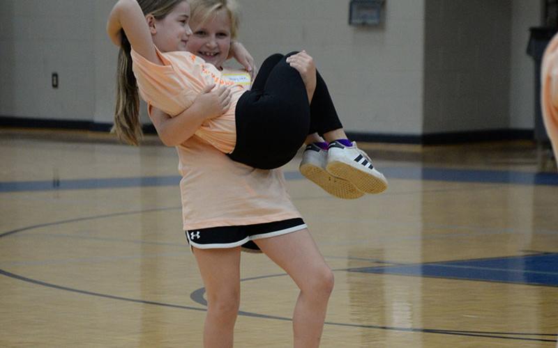 These two young dancers show off their skills for the crowd of parents and other family members at the conclusion of this year’s mini dance camp.