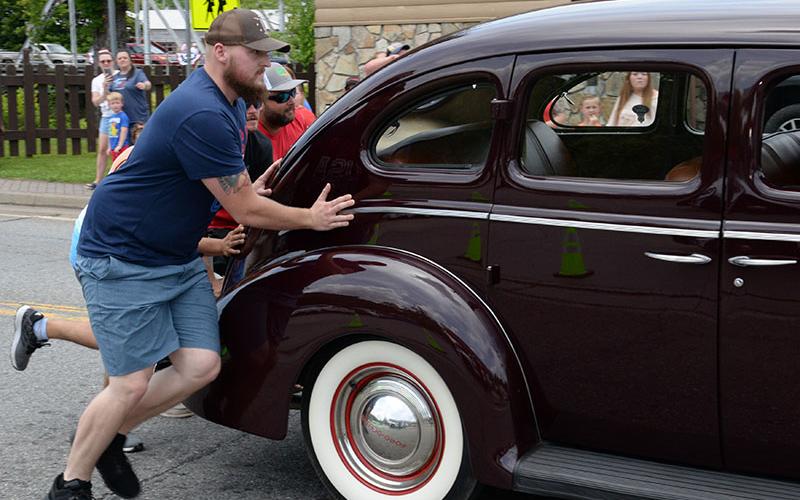 Parade watchers were eager to help when this antique car had engine trouble during the Independence Day parade in McCaysville.