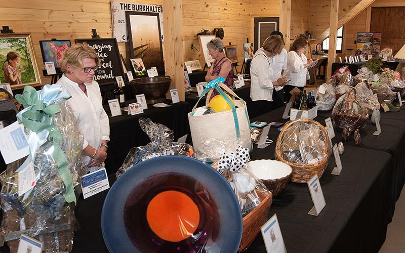 The silent auction at Paws for Celebration, the annual fundraiser of the Humane Society of Blue Ridge, attracted several bidders going after their favorite items.