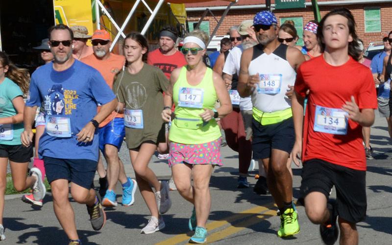 Runners take off from the start line in the Walk the Line 5K in McCaysvile. The race, part of the Riverwalk Run Series, takes competitors across the Toccoa River into Tennessee then back into Georgia in the two-state event.