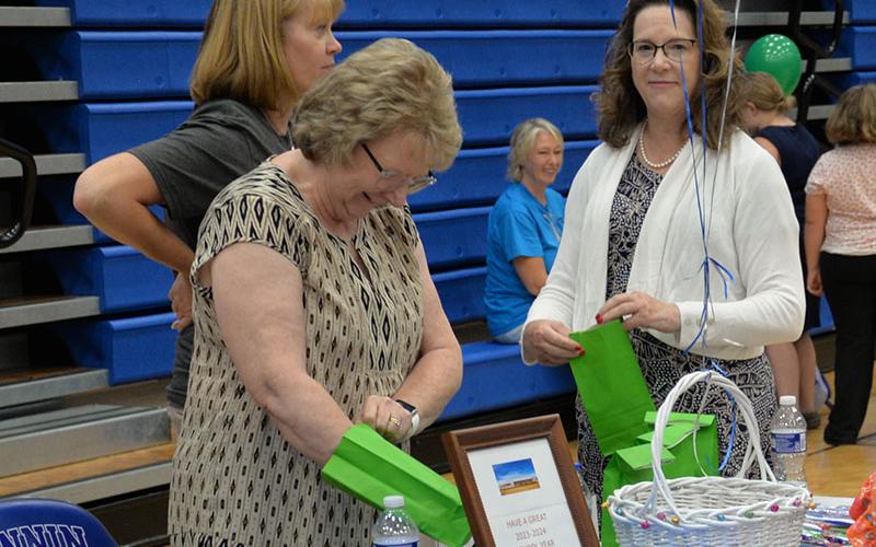 The law office of Doss &amp; Associates in Blue Ridge was one of the vendors who donated and passed out school supplies. Lynn Doss, right, has long been involved in the band program in the schools.