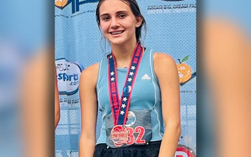 Karli Sams is shown with the medal she won as the third place finisher in the female 11 to 14 age group. She is an upcoming sophomore at Fannin County High School.