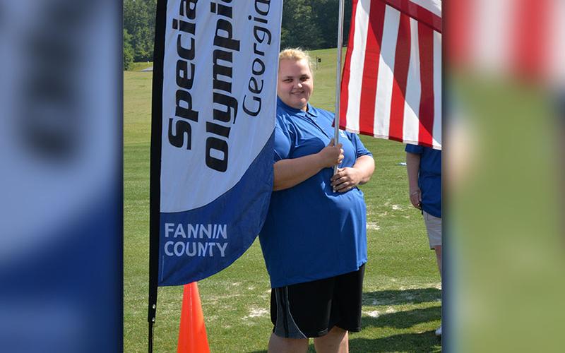 manda King holds the United States flag during the opening ceremony for Special Olympic Golf Skills Event Tuesday morning, July 25, at Old Toccoa Farm.