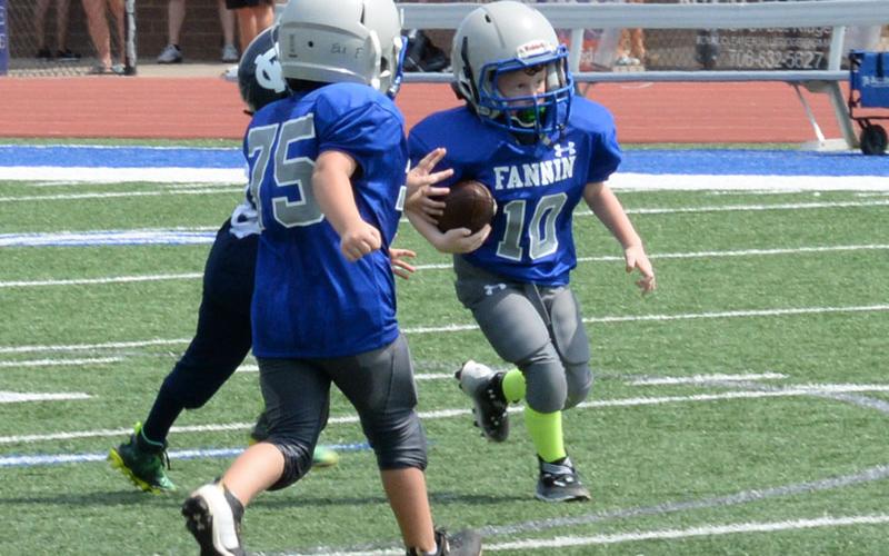 Fannin’s Eli Payne runs the ball in football game Saturday, August 12.