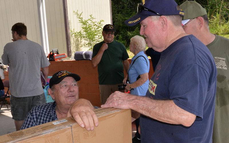 Paul Hunter, seated in the photo at left, presented Tommy Lee with a rocking chair donated by Ingles as his door prize for winning one of several drawings at the membership drive hosted by local veterans organization.