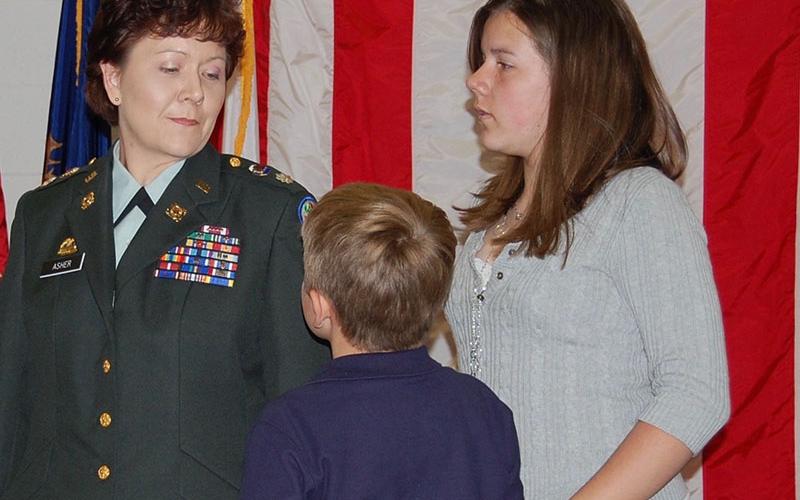 April King, who served in the Georgia Army National Guard as April Asher, is shown with her children, Christopher Asher and Taylor Asher, at her promotion ceremony to lieutenant colonel.