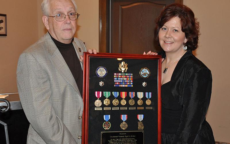 April King is shown with her father, Chief Warrant Officer 5 (retired) Robin James, at her retirement.