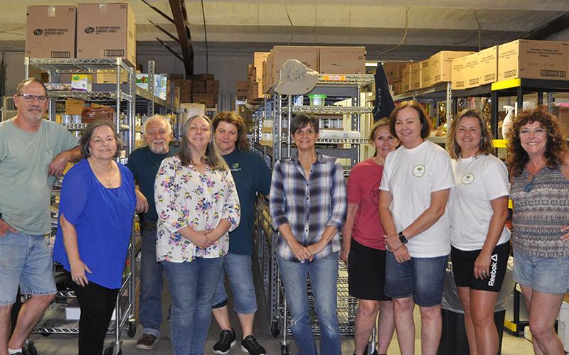Fannin County Family Connection staff and volunteers shown in the food pantry storeroom are, from left, John Jacobs (Family Care program director), Sherry Morris (executive director), Mandi Hyde (Director of Administration), Priscilla McDonald (volunteer), Michelle Kellogg (volunteer), Karen Walton (volunteer), Kathy Jones (volunteer), Kala Ballew (Food Pantry manager), and Diane Treadway (visiting volunteer).