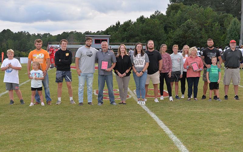 Shown during the Hometown IGA Legends of the Game presentation Friday night at Copper Basin High School are, from left: Toby Griffeth, Bree Muse, Austin Muse, Spence Griffith, Dylan Boggs, Andy Whitener, Beth Whitener, Bailey Stone, Trevor Stone, Jaidyn Griffeth, Maddox Griffeth, Leigh Griffeth, Jenny Muse, Parker Muse, Brad Muse, and John Spargo.